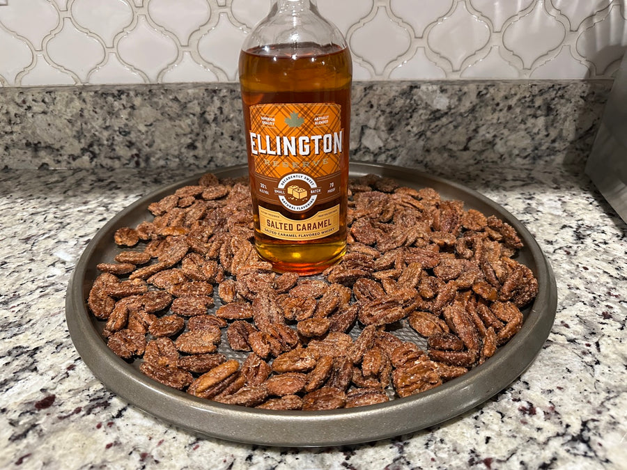Salted Caramel whiskey bottle with tray of candied pecans